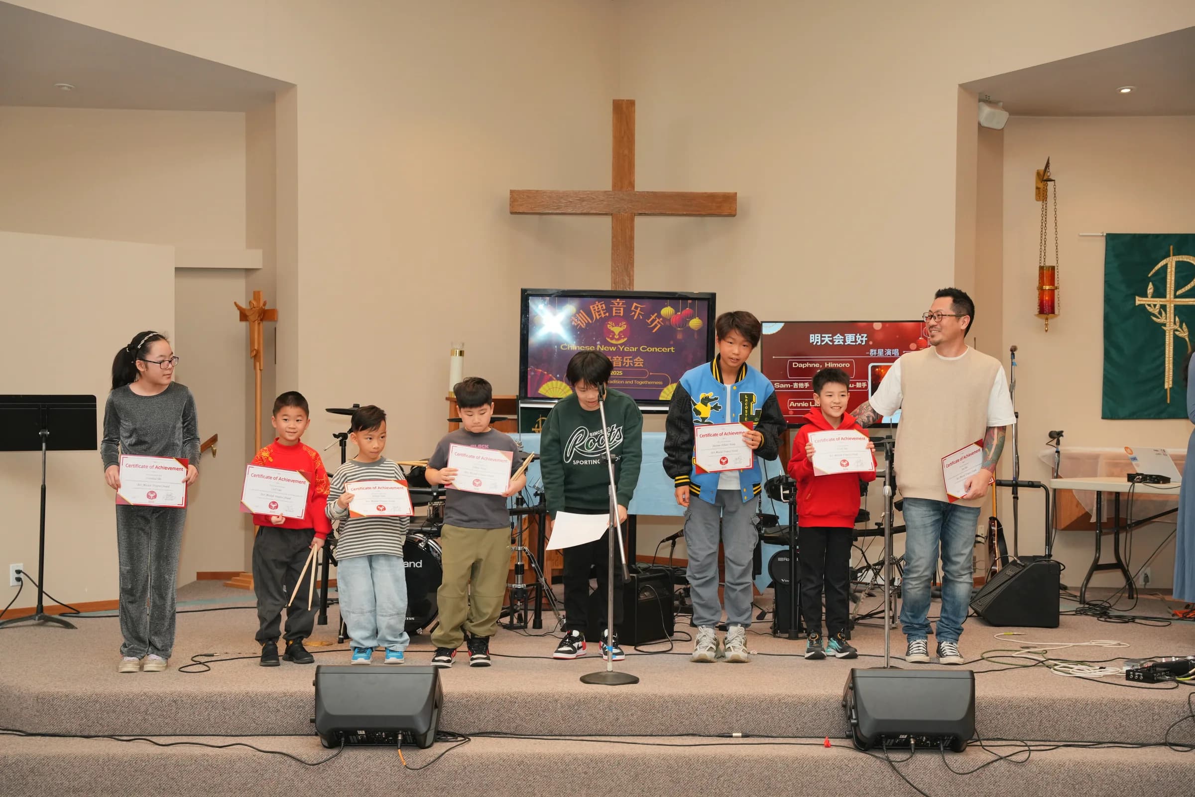 Best Musical Progress Award recipients standing on stage with their certificates.