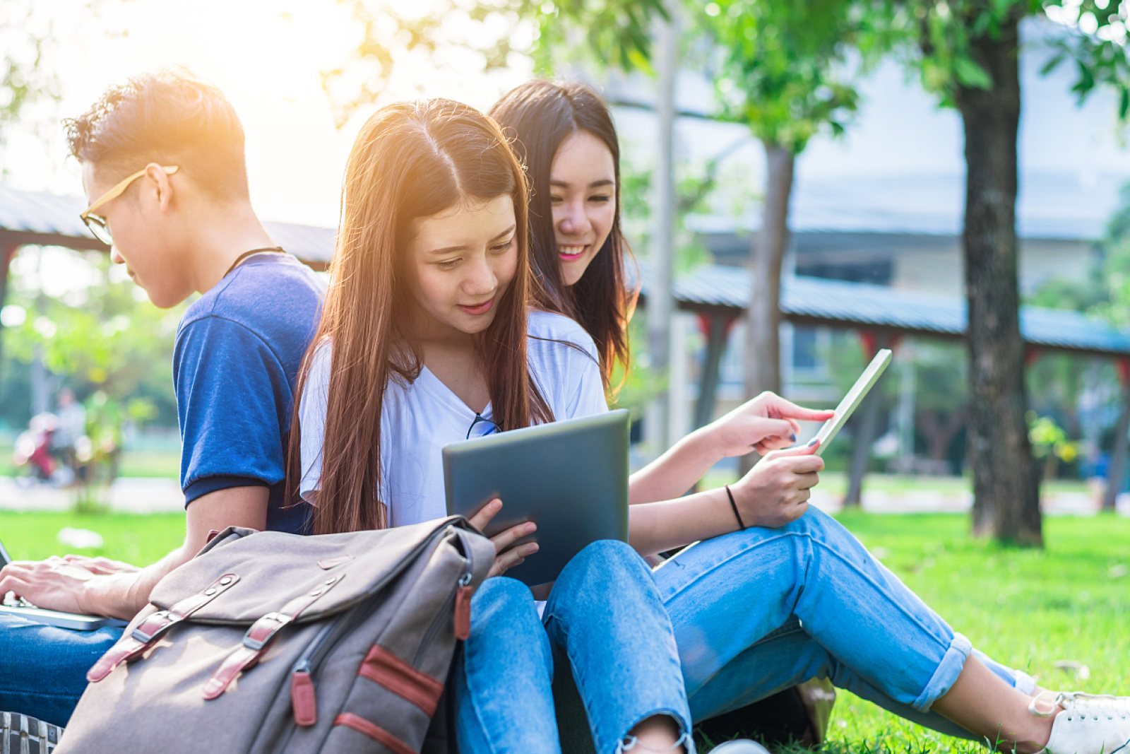 Elementary students reading together outdoors