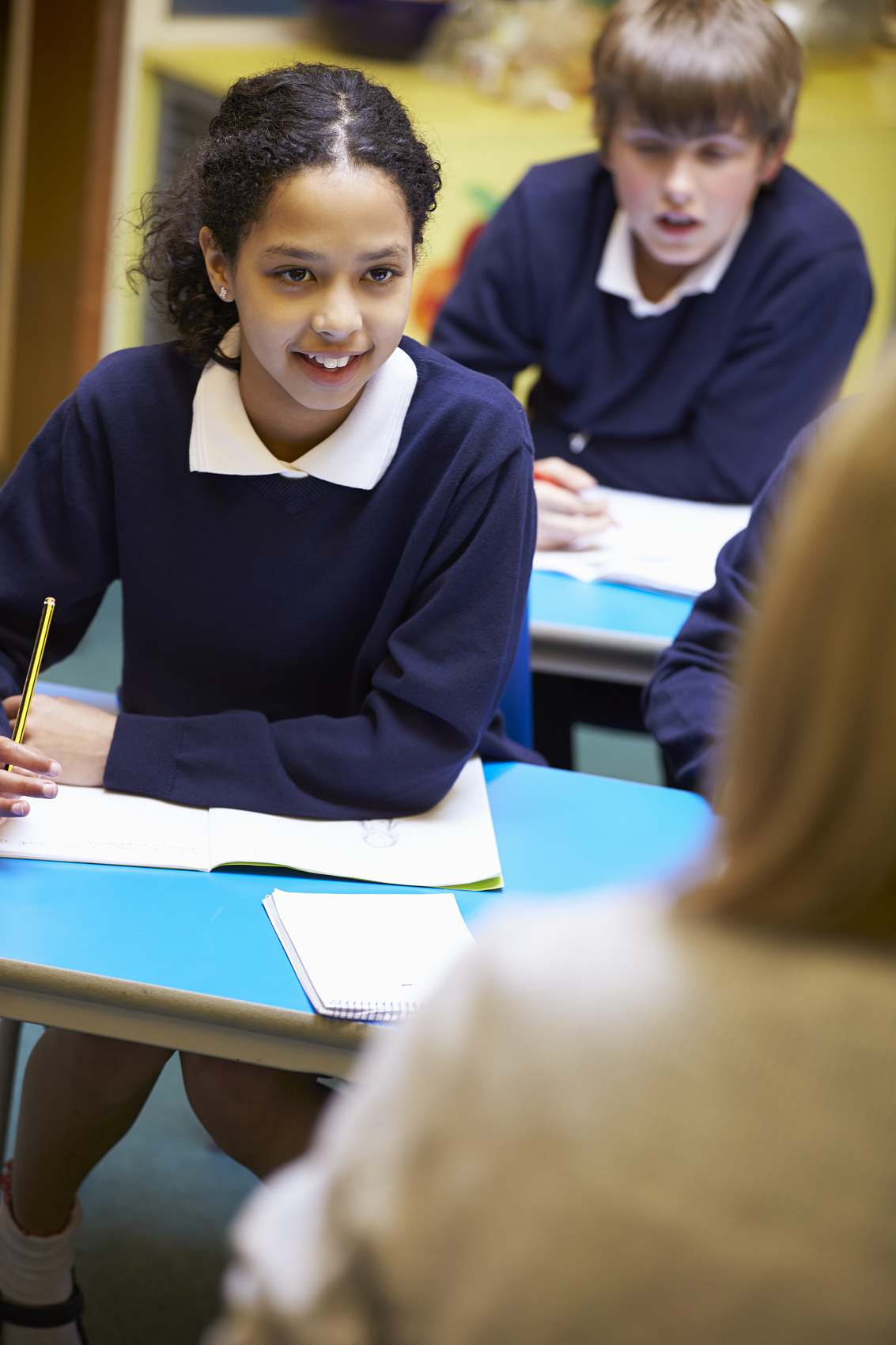 Students listening and working in a classroom