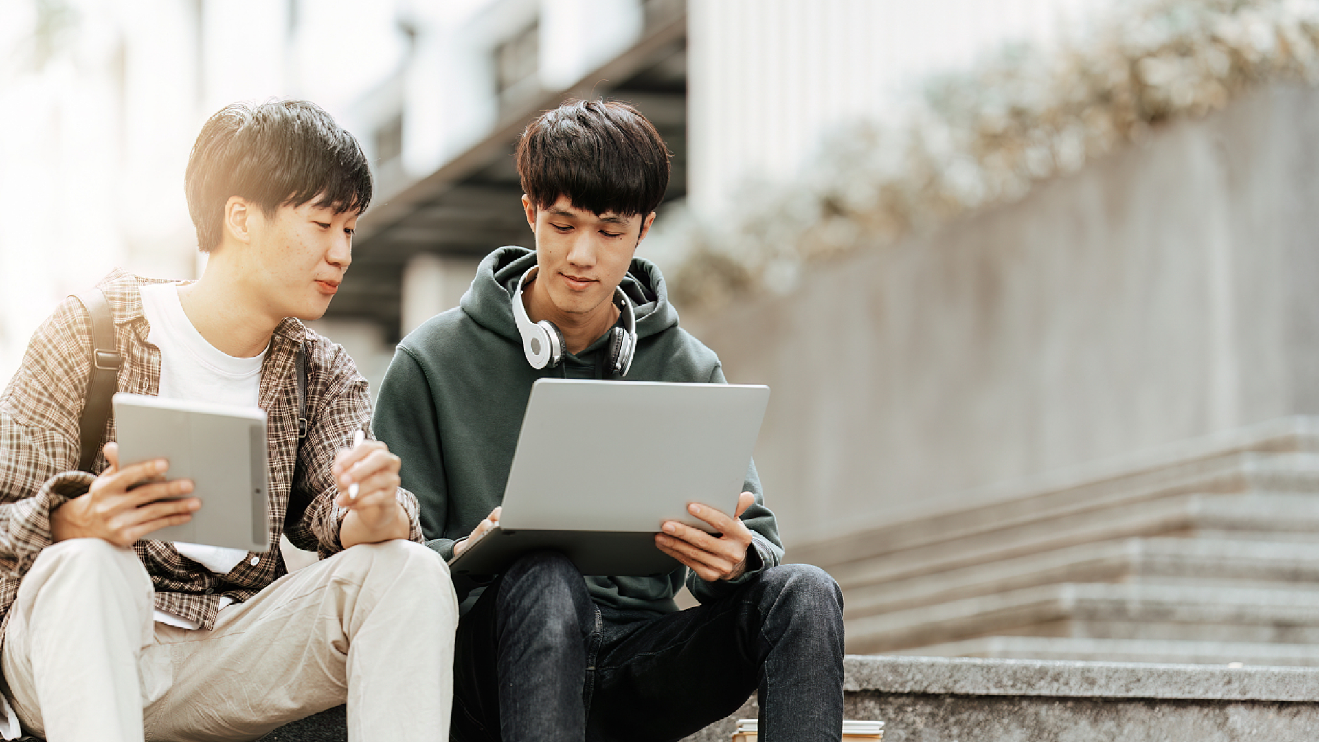 Students studying together with a tablet and books