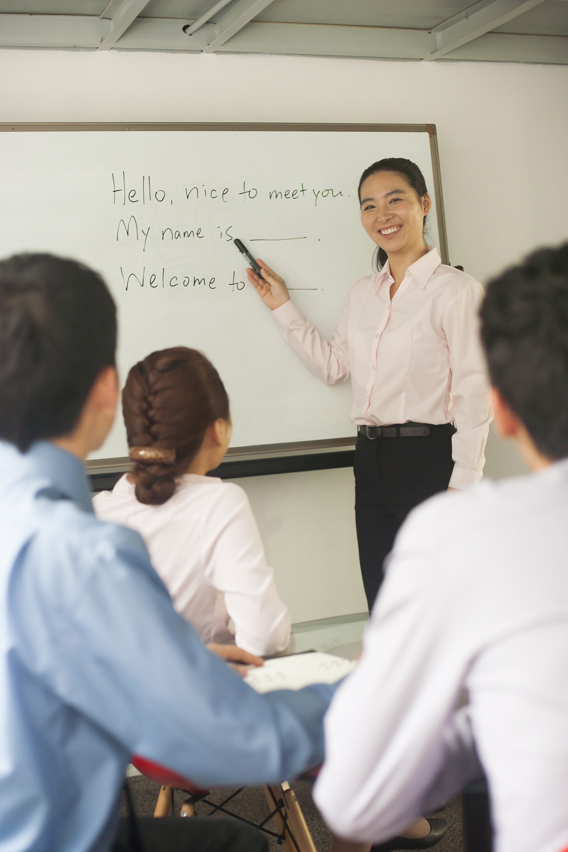 Teacher guiding students in an English class