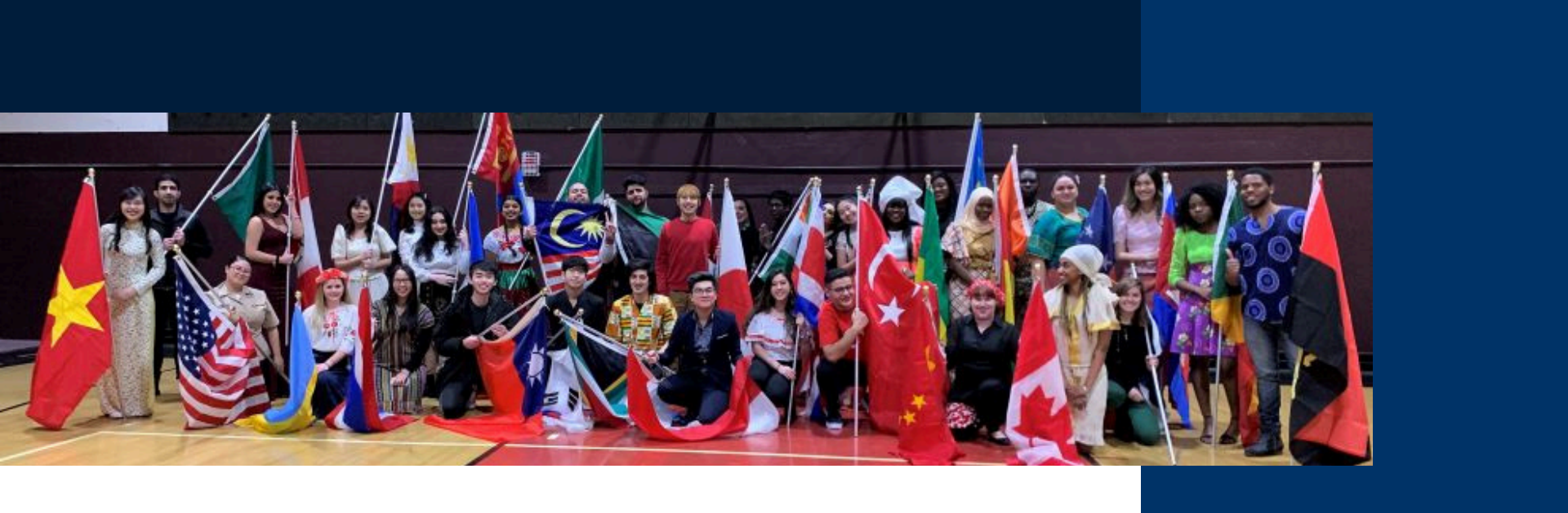 Students holding flags in a university group photo